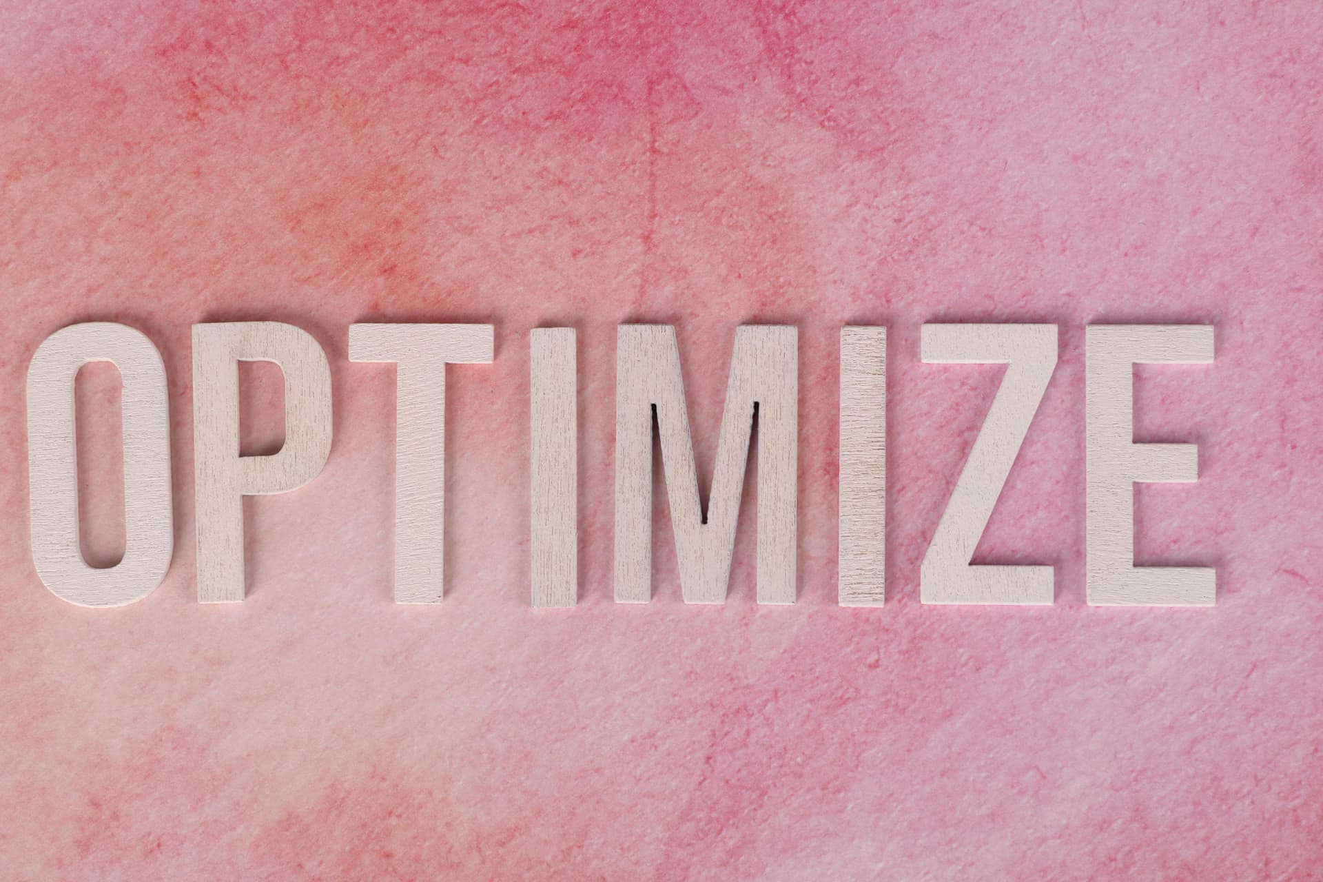 Optimize text on pink background representing content optimization strategy